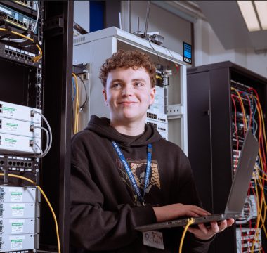 Male digital and IT student in a server room