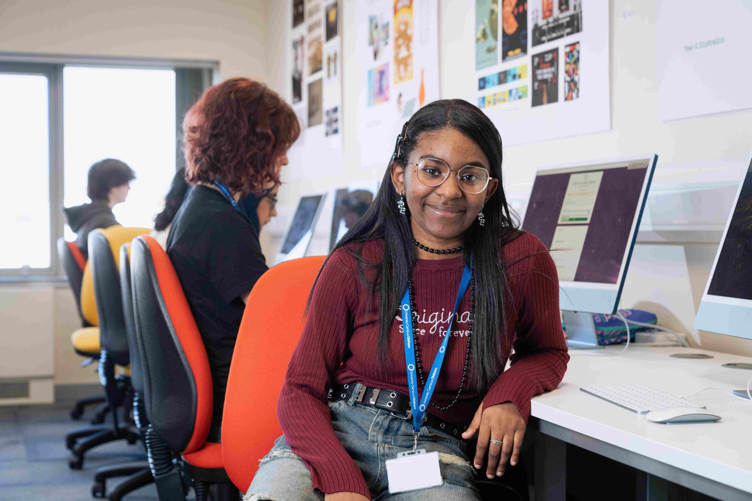 Female creative university student sitting down at a computer desk
