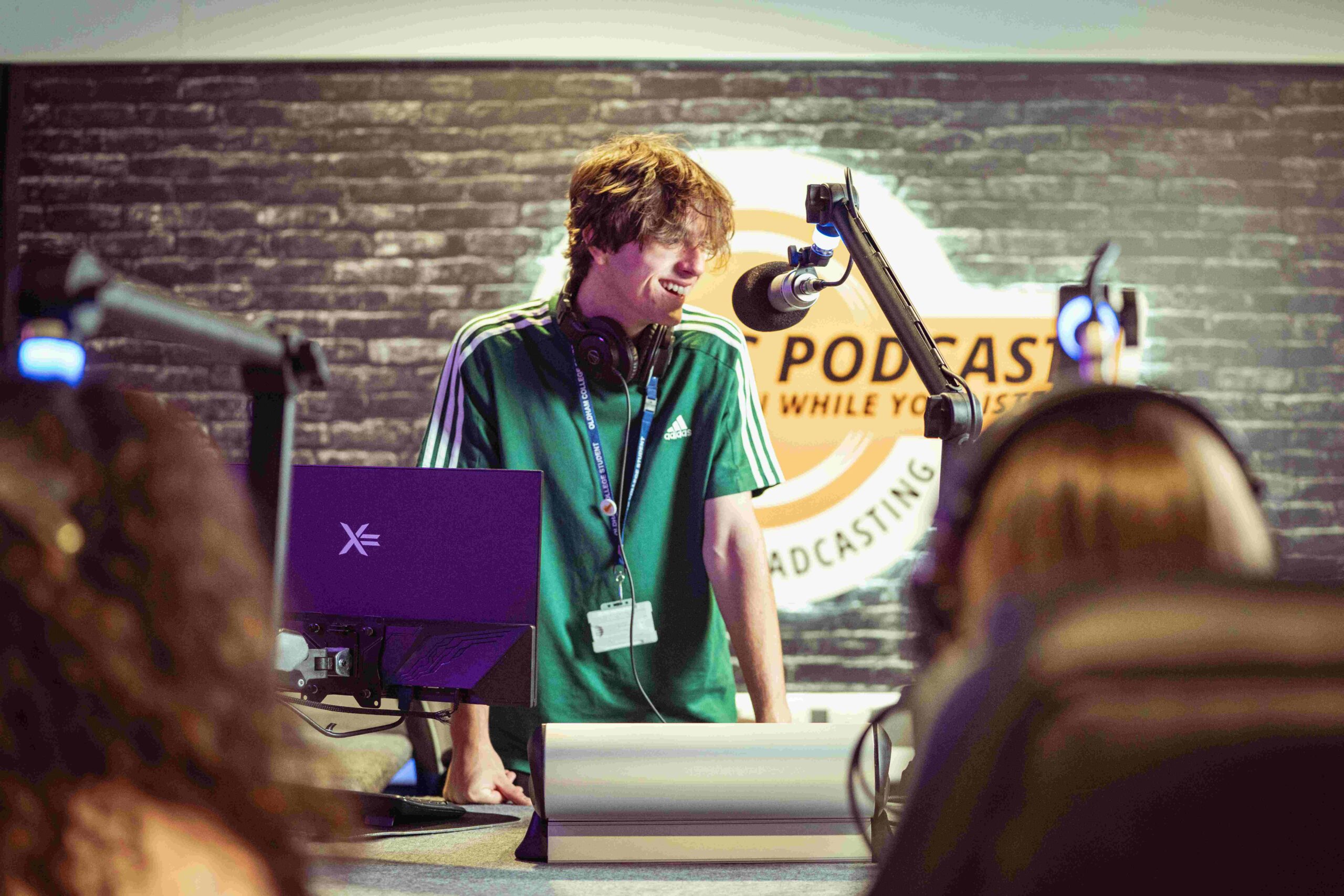 Male college learner using a podcast studio