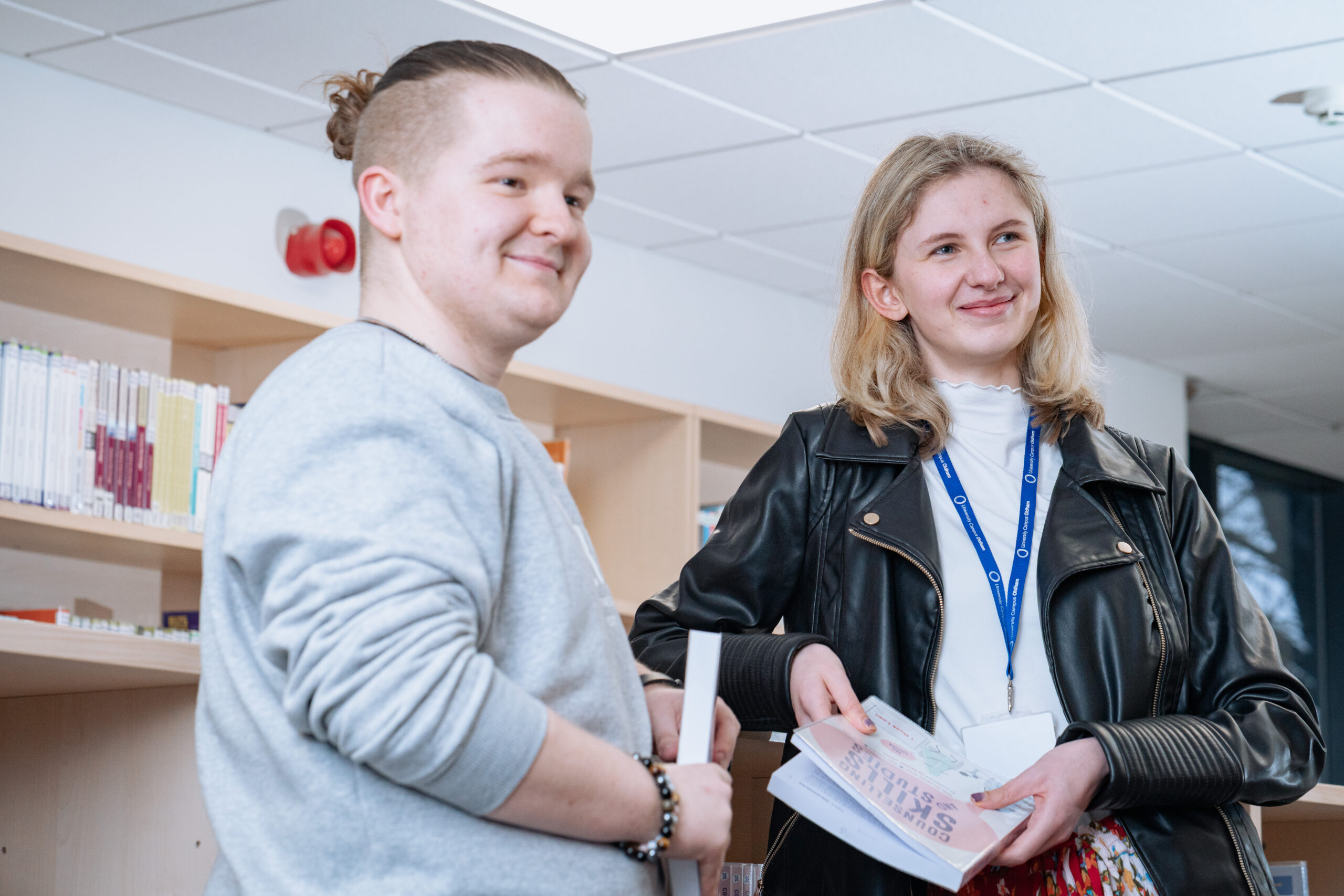 Two university students standing up