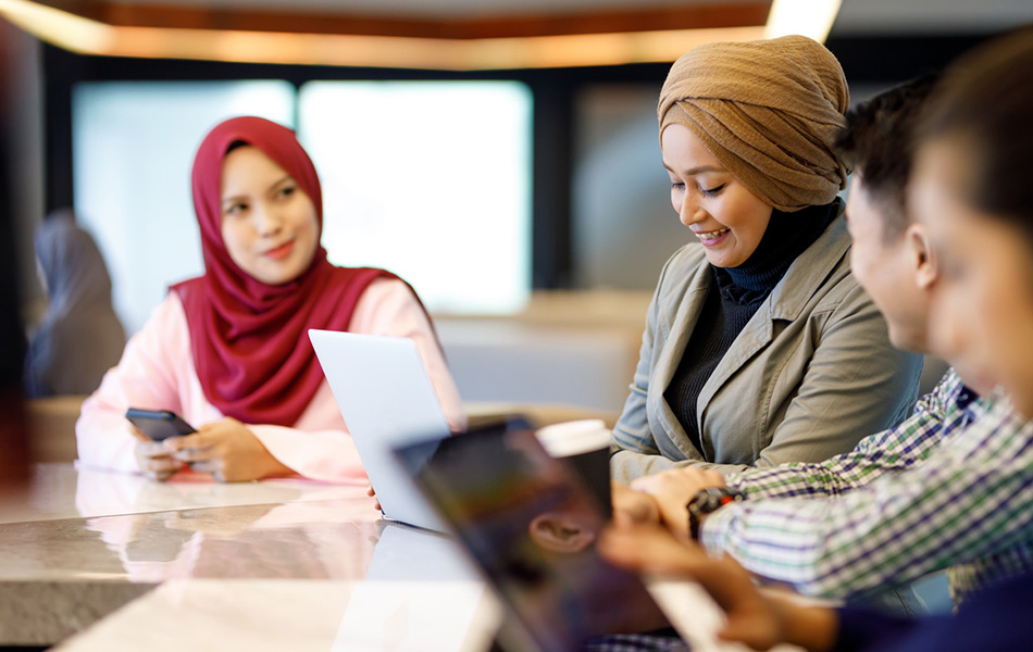 Mixed nationalities working at a desk together