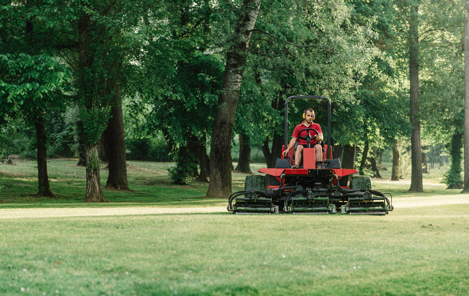 Man on a sit on mower cutting the grass